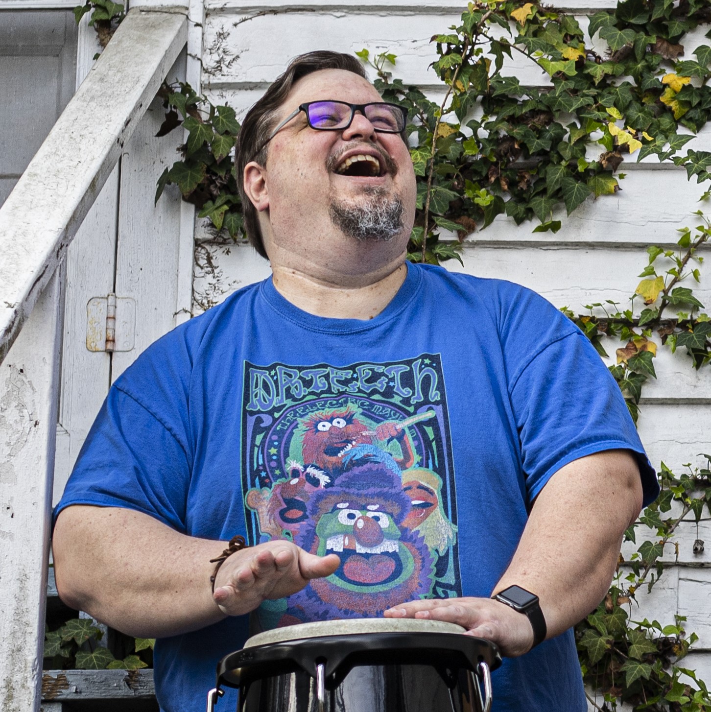 A person with glasses laughing  AI-generated content may be incorrect.